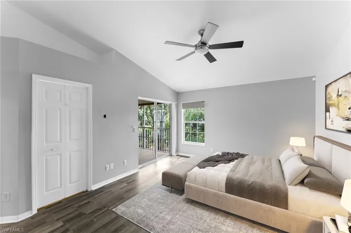 Bedroom with access to exterior, dark hardwood / wood-style floors, ceiling fan, and vaulted ceiling