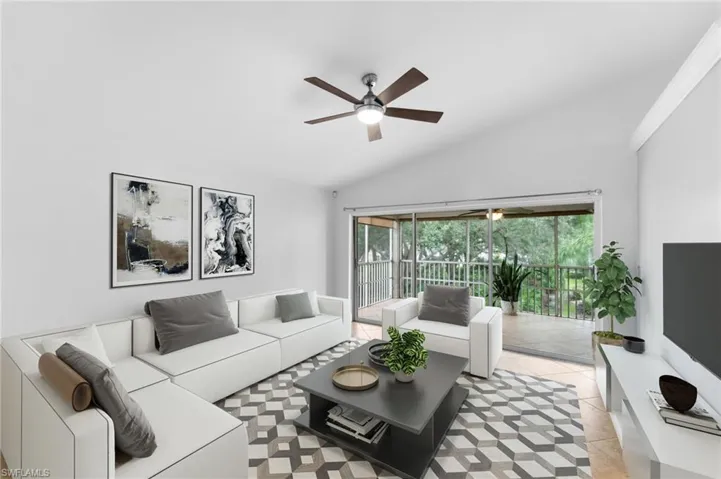 Tiled living room with ceiling fan and vaulted ceiling
