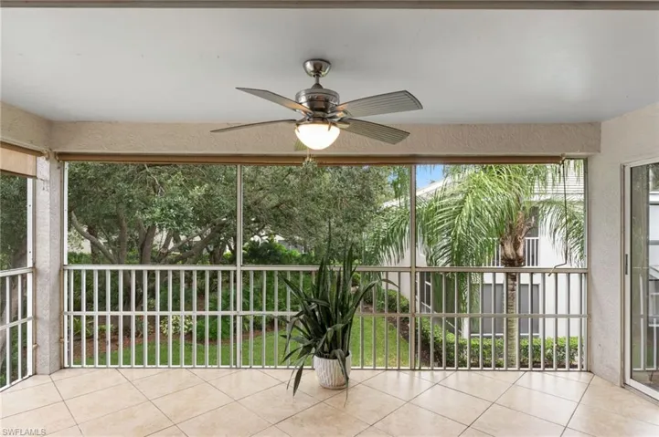 Unfurnished sunroom featuring ceiling fan