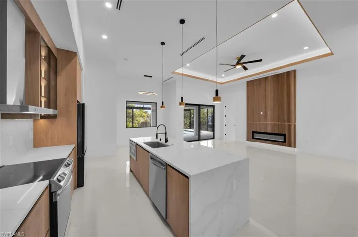Kitchen with a raised ceiling, range with electric cooktop, modern cabinets, and dishwasher