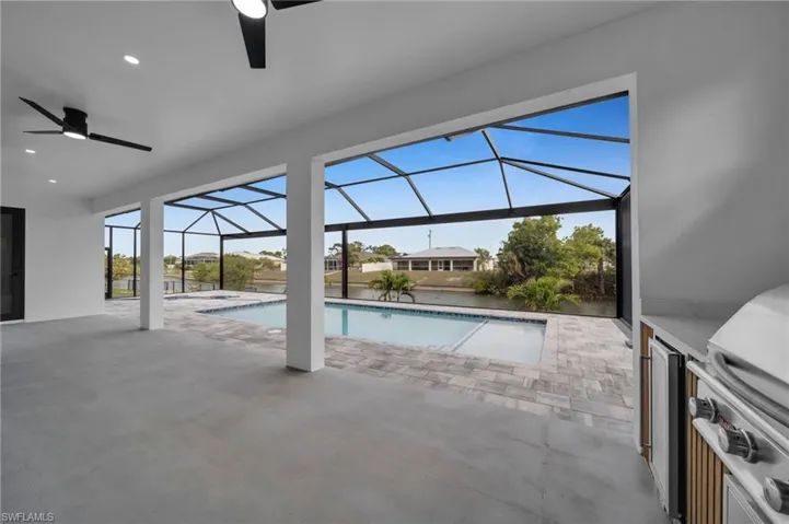 Pool with a patio, area for grilling, a lanai, and a ceiling fan