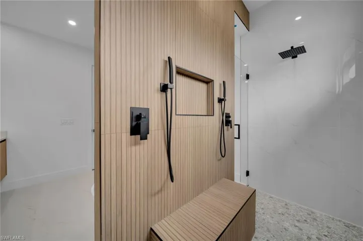 Full bath with recessed lighting and a marble finish shower