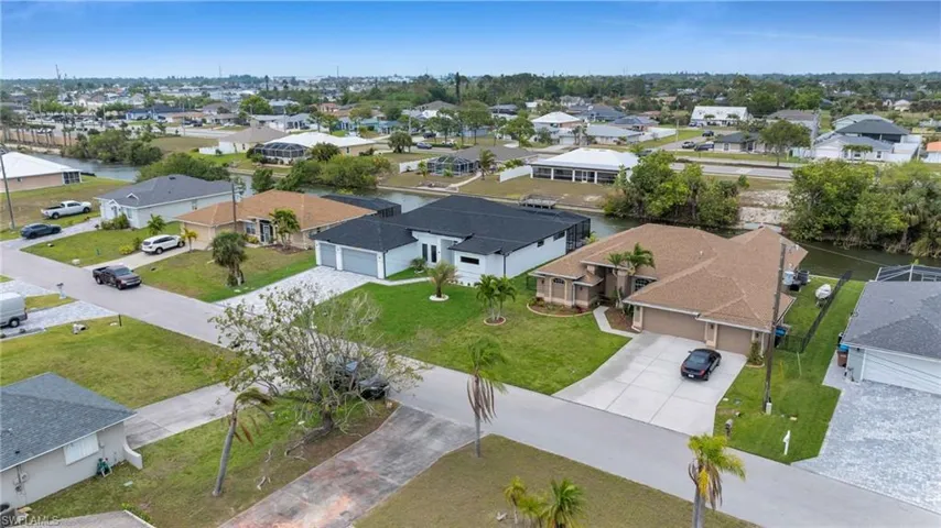 Birds eye view of property with a residential view and a water view
