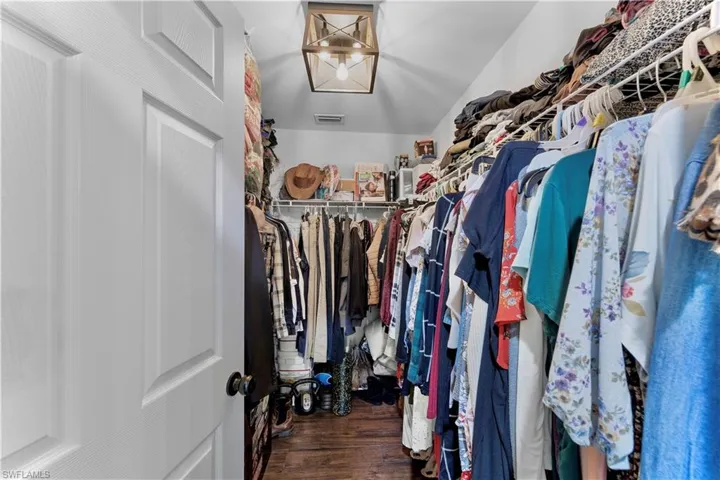 Spacious closet featuring visible vents and wood finished floors