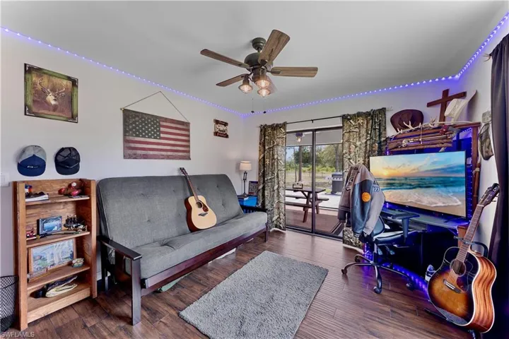 Living room featuring ceiling fan and wood finished floors