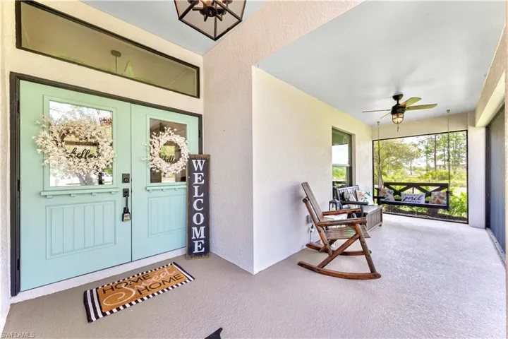 Entrance to property with covered porch and ceiling fan