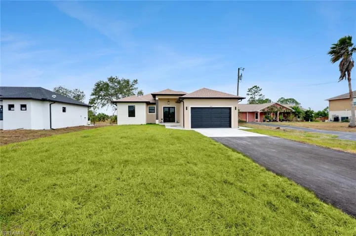 View of front facade with a garage and a front yard