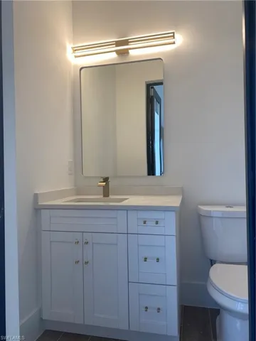 Bathroom featuring tile patterned floors, vanity, and toilet