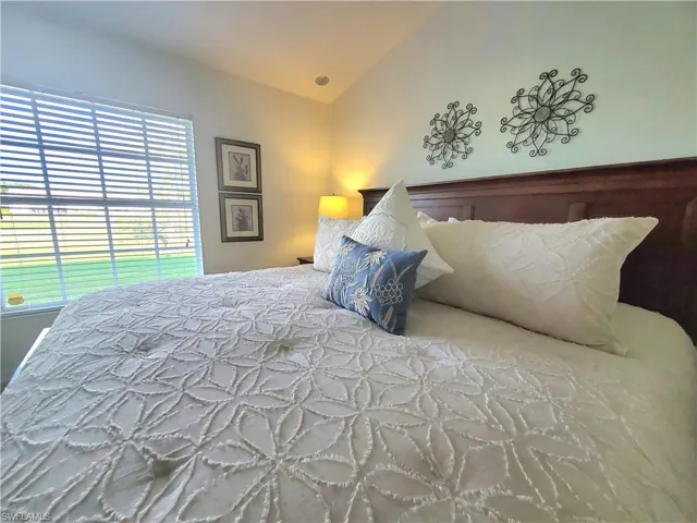 Bedroom featuring lofted ceiling