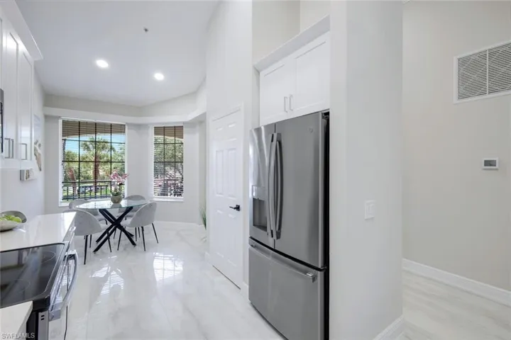 Kitchen with appliances with stainless steel finishes and white cabinets
