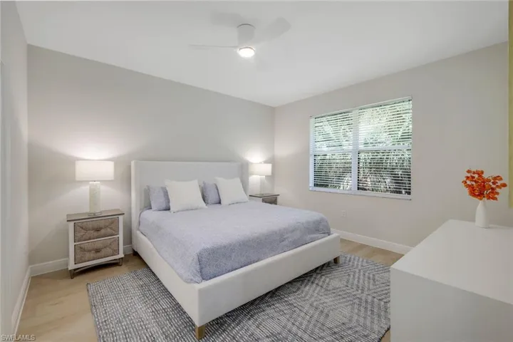 Bedroom with light hardwood / wood-style floors and ceiling fan