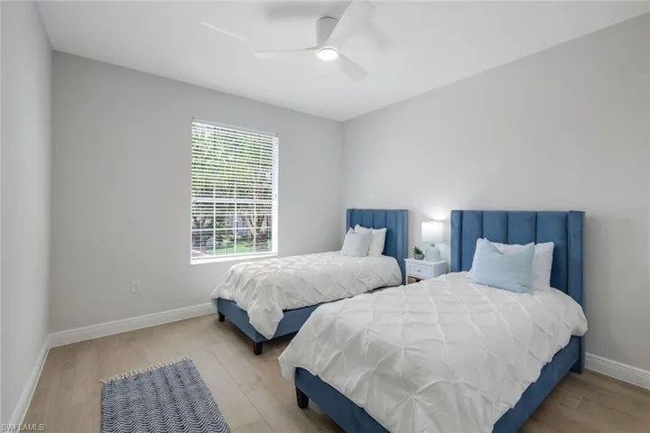 Bedroom with ceiling fan and light wood-type flooring