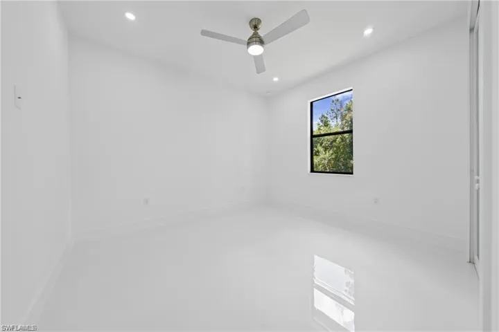 Empty room featuring recessed lighting, ceiling fan, and concrete floors