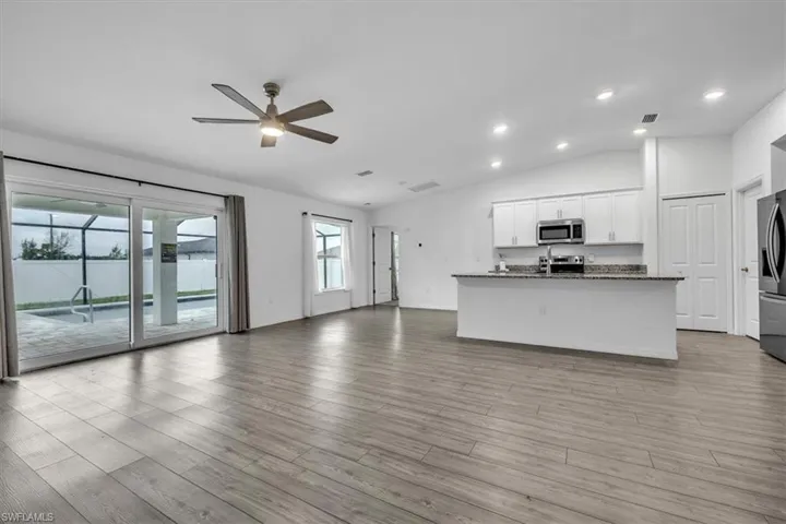 Spare room with ceiling fan and light wood-type flooring