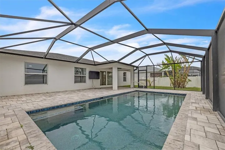 Outdoor pool featuring a patio, a sunroom, and a lanai