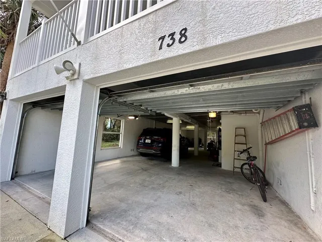 Ground level, covered 4 car garage, storage, and utility area.