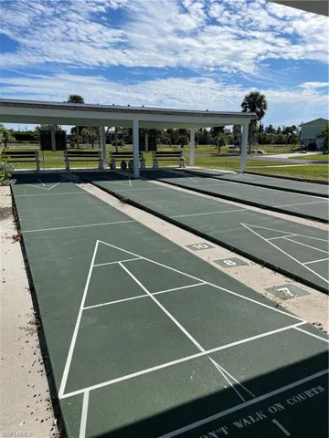 Surrounding community featuring shuffleboard and a lawn