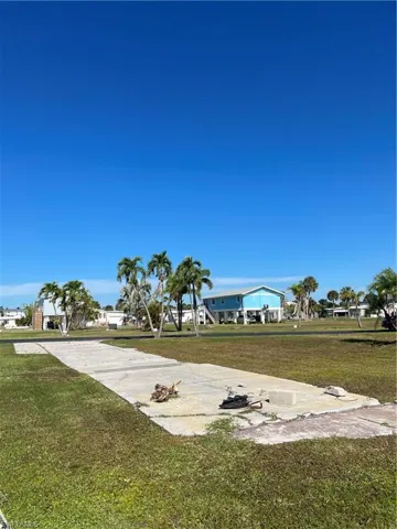 View of property's community with a lawn