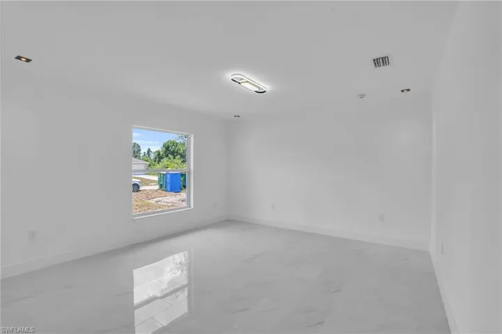 Spare room featuring light tile floors