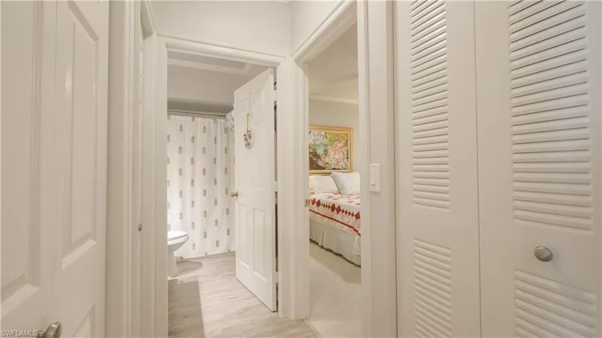 The hallway into the guest room and bathroom has LVT flooring, ceiling detail, and crown moulding. Each bedroom is PRIVATE retreat.