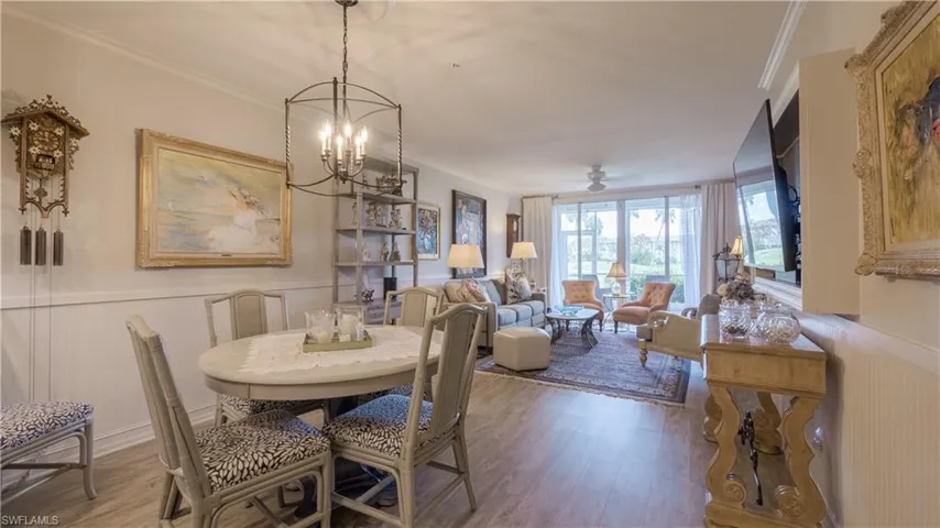 Luxury vinyl flooring is throughout the foyer, kitchen, dining and living areas. High-end light fixtures, chair rail w/ beadboard and wide base trim adorn the area too. (Furniture may be slightly different than pictured.)