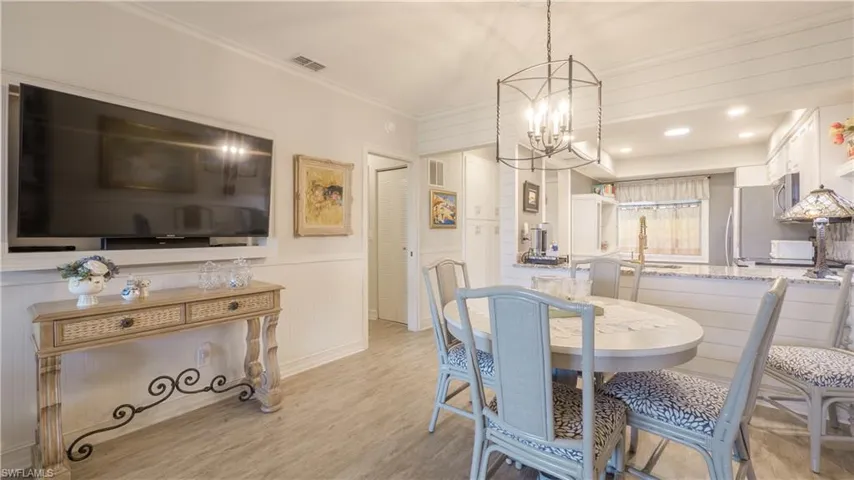 The custom framed TV w/swivel bracket feature provides comfortable viewing for the kitchen, dining, and living areas. Outlets and cords are concealed.