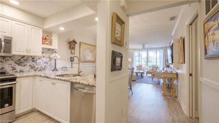 Welcome home to Sawgrass #105! Once inside, your eye is drawn to the kitchen, but the golf course can also be seen just beyond the living area.