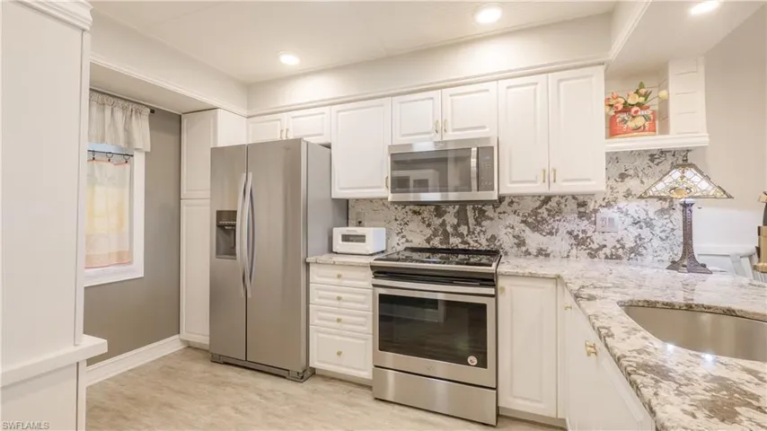 Trim updates include wider baseboards, crown moulding, and custom window millwork for the doors & windows. Be sure to look UP! The ceiling in the kitchen has great task lighting and beadboard.