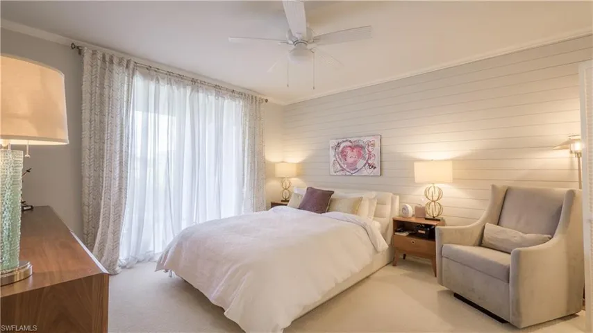 The Master Bedroom has a ship-lap feature wall, crown moulding, newer plush carpet for a luxurious feel and an intimate sitting area.