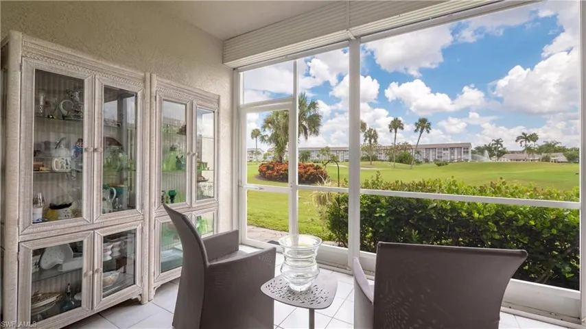 The deep set & expansive 23' x 8' screened-in lanai has a fantastic view of the #2 tee box and beyond  - all the way to the ponds and water features! Picture yourself enjoying conversation over coffer or cocktails.