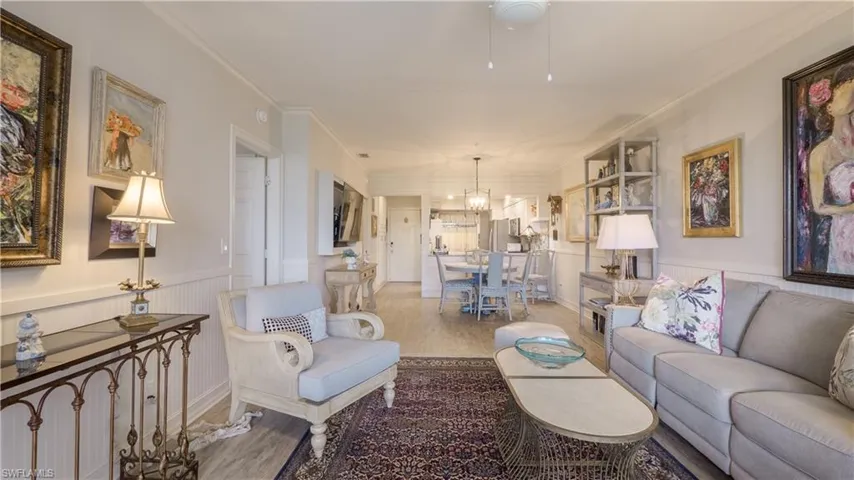 This view is from the lanai looking into Sawgrass #105's living area, dining and all the way to the front door. Notice the added architectural feature - a header was installed to specifically define the foyer.