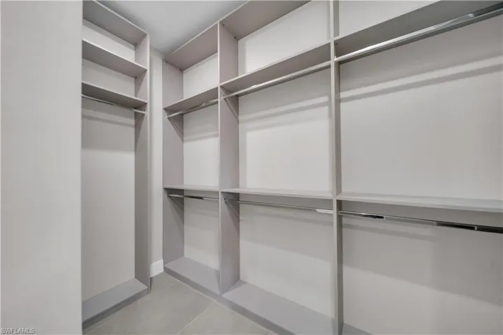 Spacious closet featuring light tile patterned flooring