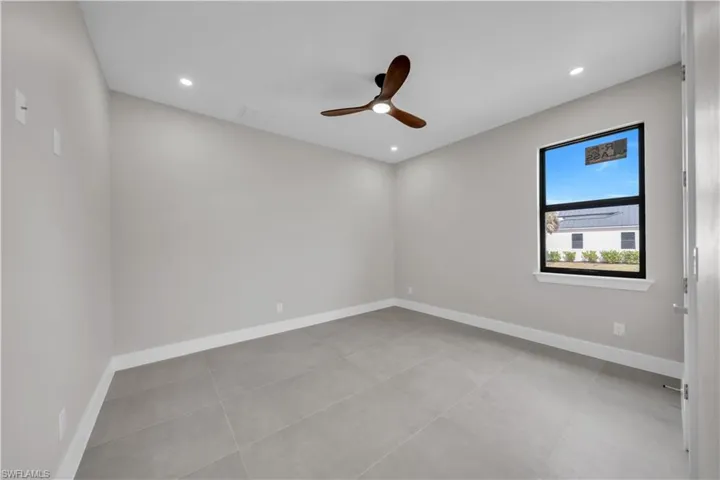 Spare room with a ceiling fan, recessed lighting, and light tile patterned floors