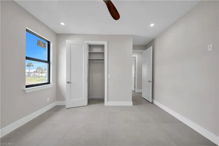Unfurnished bedroom with ceiling fan, recessed lighting, and a closet