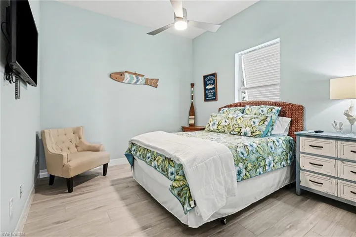 Bedroom with light wood-style flooring and a ceiling fan