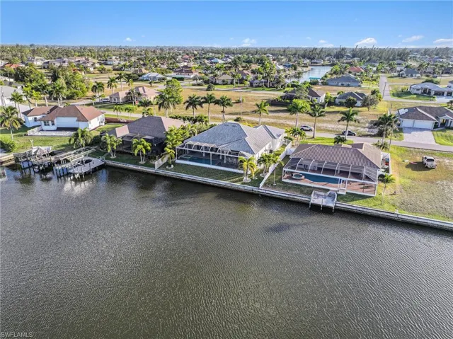 Aerial view of residential area featuring a large body of water