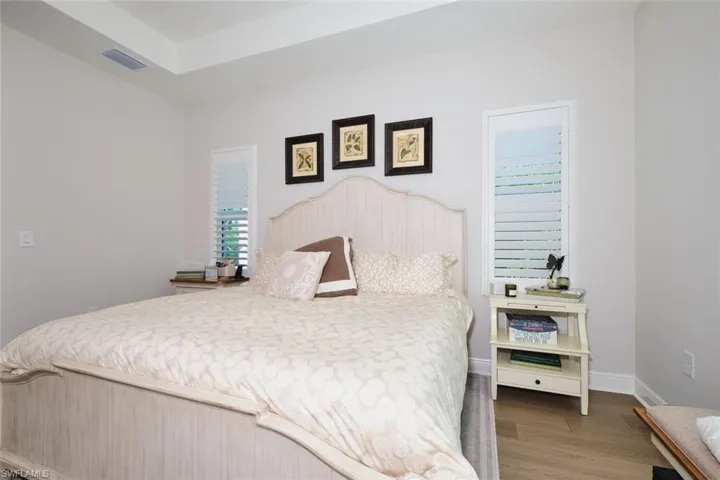 Bedroom with light wood finished floors and baseboards