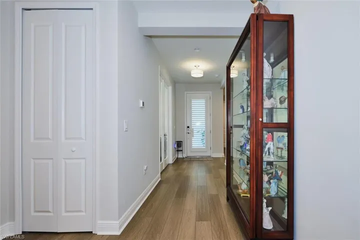 Hallway with wood finished floors and baseboards