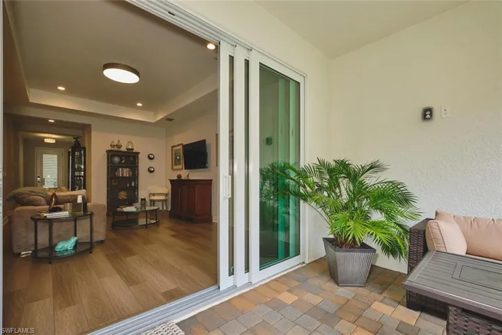 Property entrance with stucco siding and a patio