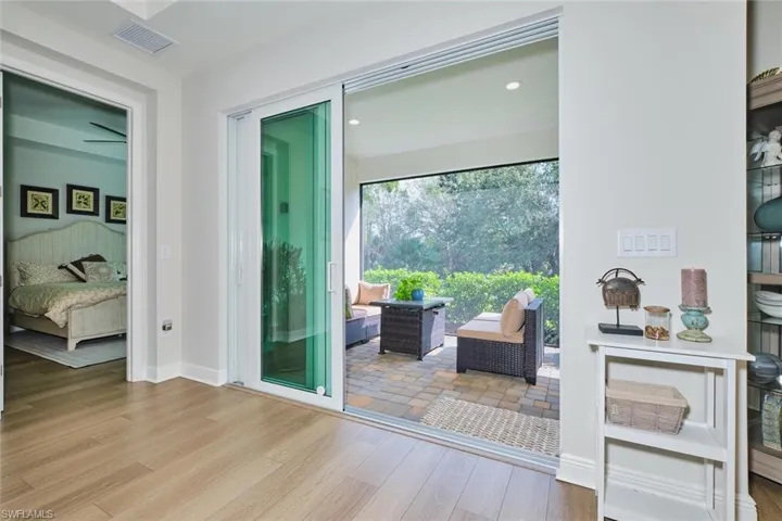 Entryway with wood finished floors and recessed lighting