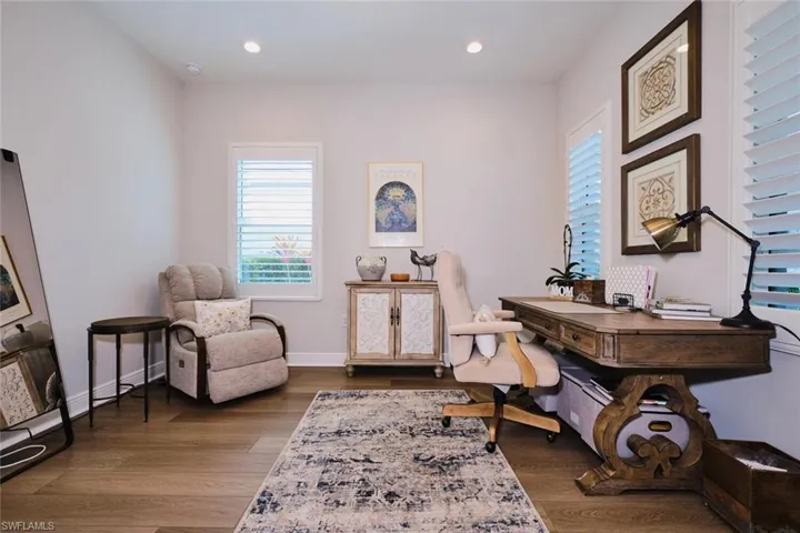 Office area featuring dark wood finished floors and recessed lighting
