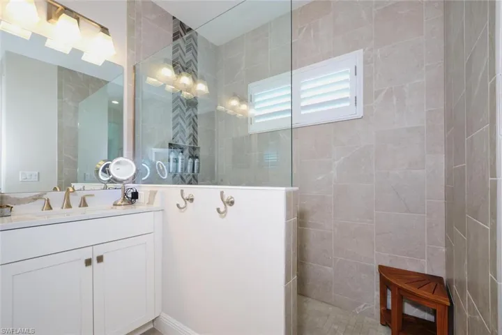 Full bath with walk in shower and vanity
