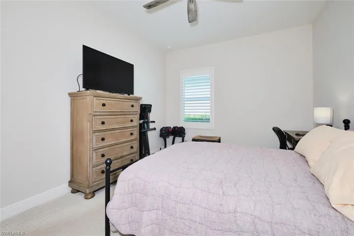 Bedroom featuring light colored carpet and ceiling fan