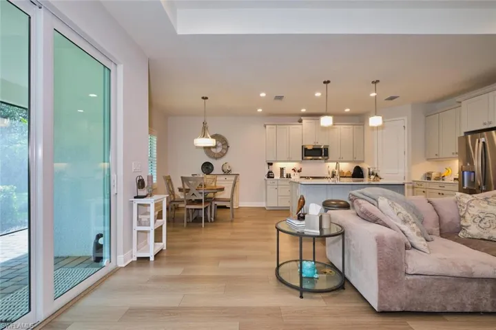 Living area with light wood-style floors and recessed lighting