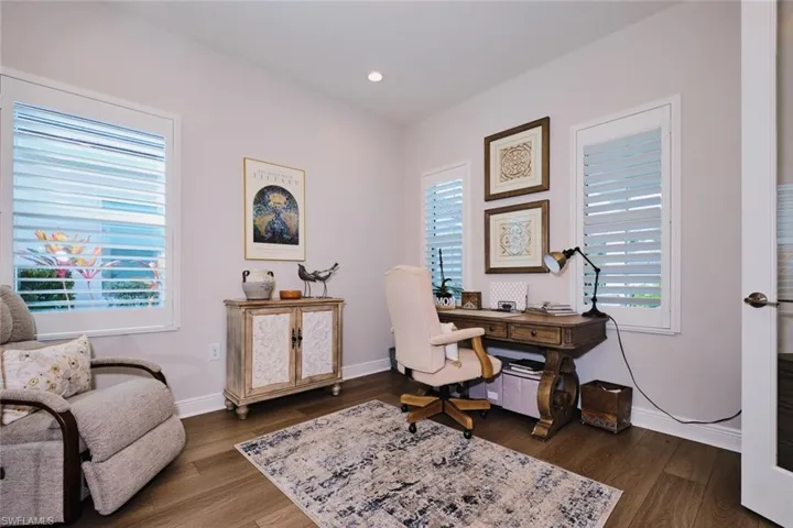 Office area with dark wood-style floors and recessed lighting