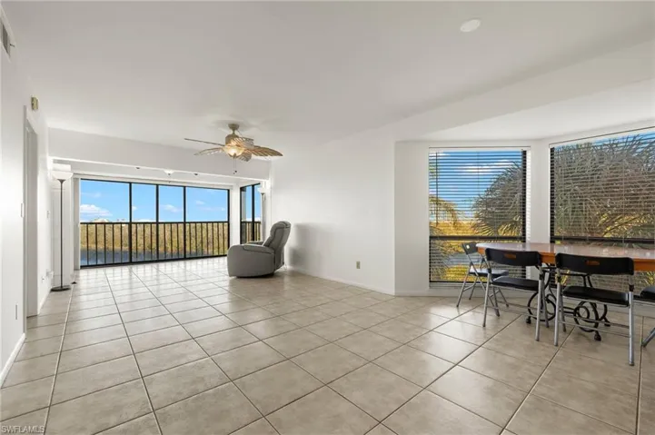 Living area with light tile patterned floors and ceiling fan