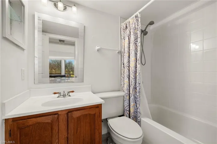 Full bathroom with shower / bath combo, toilet, and vanity