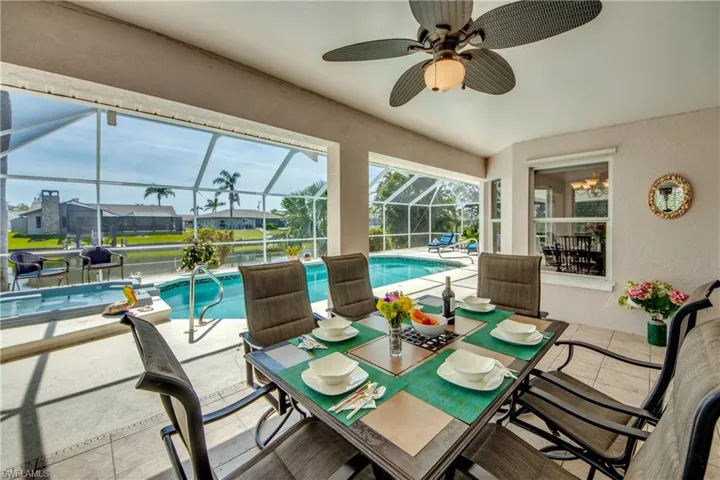 Sunroom featuring a pool and ceiling fan