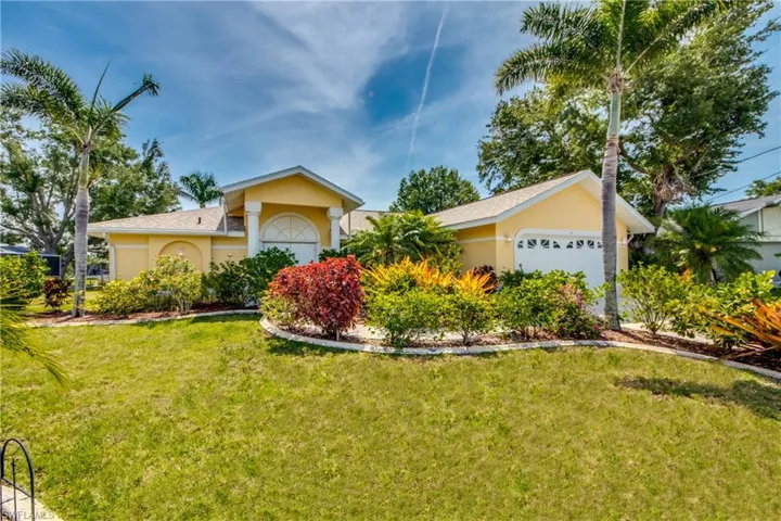 Single story home featuring a front lawn and a garage