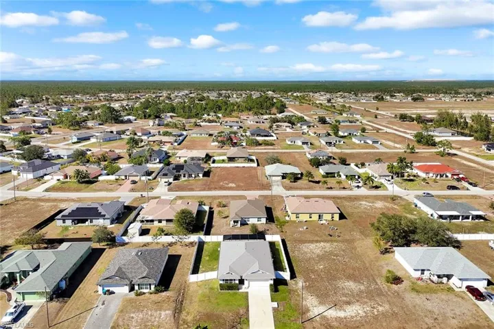 Aerial view of property's location featuring nearby suburban area